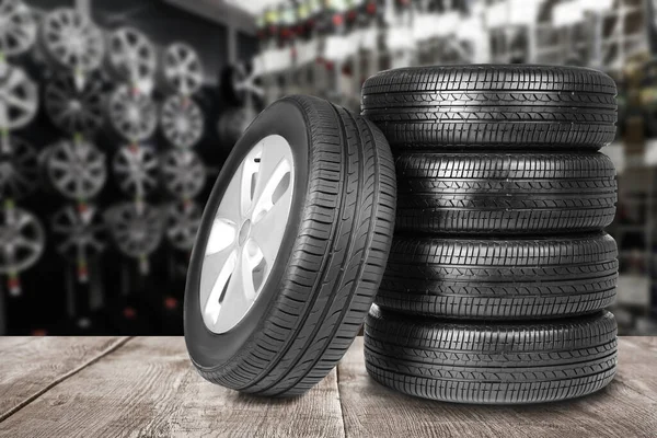 depositphotos_367993716-stock-photo-car-tires-grey-wooden-surface